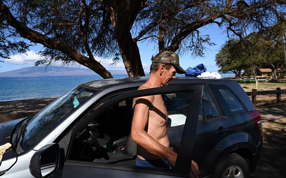 Dan Reardon stands near his car at Hanakao’o Park in Lahaina, Hawaii, on Tuesday, Aug. 15, 2023. He has been living on the beach since the fires that devastated the town last week.