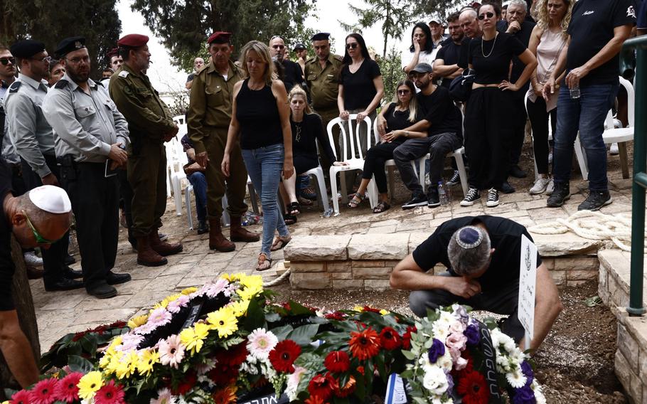 Family and friends attend the funeral of Afik Rozental, an Israeli soldier killed during fighting with Gaza militants, in Kfar Menahem, Israel, on Oct. 9.