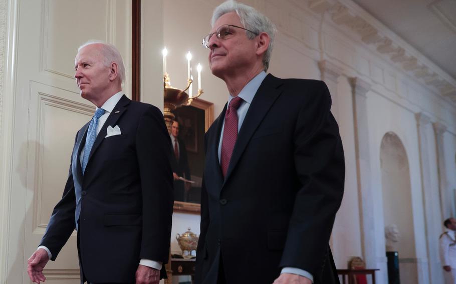 President Biden and Attorney General Merrick Garland arrive in the East Room of the White House in Washington on May 16, 2022.