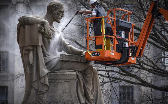 Contractors give a spring cleaning to Robert Aitken's statue from 1935 of Socrates, located on the Pennsylvania Avenue side of the National Archives in Washington, on April 4, 2017. MUST CREDIT: Washington Post photo by Bill O'Leary.