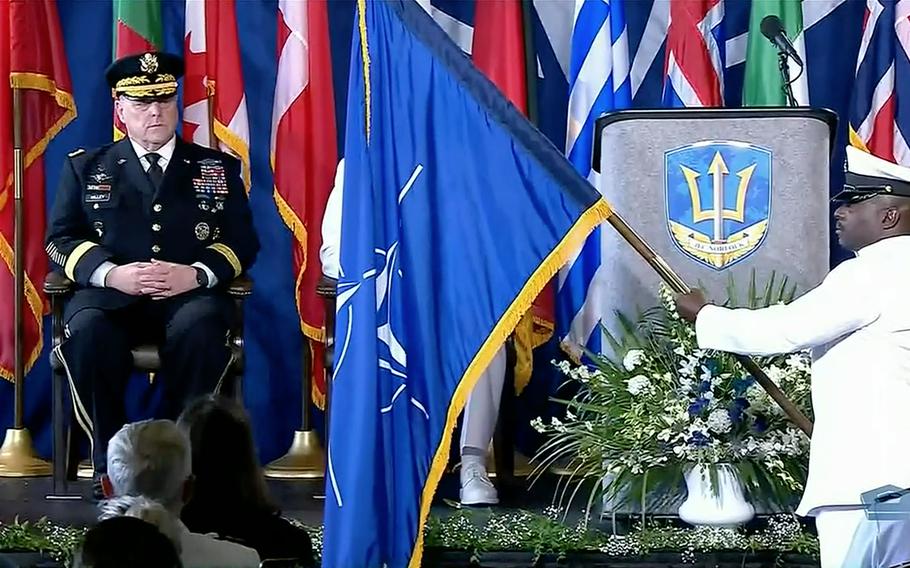 In a screenshot from a Defense Department live feed, Army Gen. Mark A. Milley, chairman of the Joint Chiefs of Staff, watches as the NATO flag is presented aboard the USS Kearsarge during a ceremony marking the alliance’s Joint Force Command Norfolk fully operational, July 15, 2021. JFC Norfolk is the only NATO joint command in the U.S.