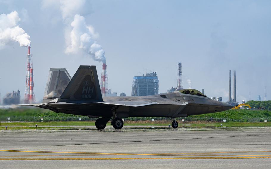 An Air Force F-22 Raptor sits on the flight line during Agile Combat Employment training at Marine Corps Air Station Iwakuni, Japan, on June 22, 2022.