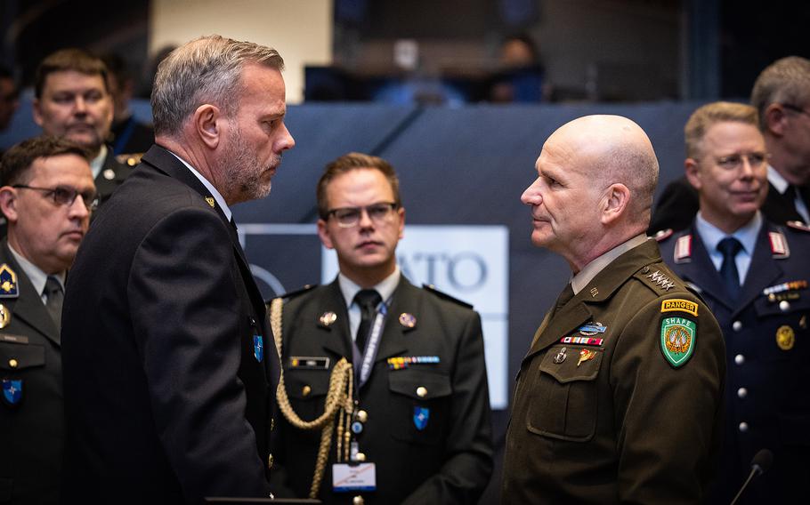 The chair of the NATO Military Committee, Dutch Adm. Rob Bauer, and U.S. Army Gen. Christopher Cavoli, NATO’s supreme allied commander, talk before a session of the alliance's defense chiefs meeting in Brussels on Jan. 17, 2024. 