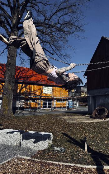 A person on a swing with feet in the air