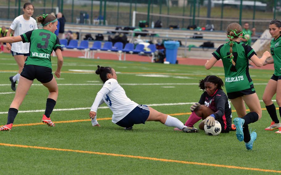 Naples keeper Noya Dillard gets her hands on the ball before Black Forest Academy’s Esther Lee in girls Division II finals at the DODEA-Europe soccer championships in Ramstein, Germany, May 22, 2025. Naples won the game 3-0.