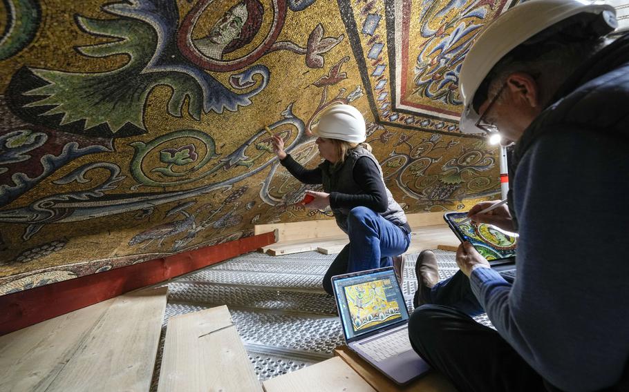 Restorers Chiara Zizola, right, and Roberto Nardi work at the restoration of the mosaics that adorn the dome of one of the oldest churches in Florence, the Baptistery of San Giovanni, Feb. 7. 