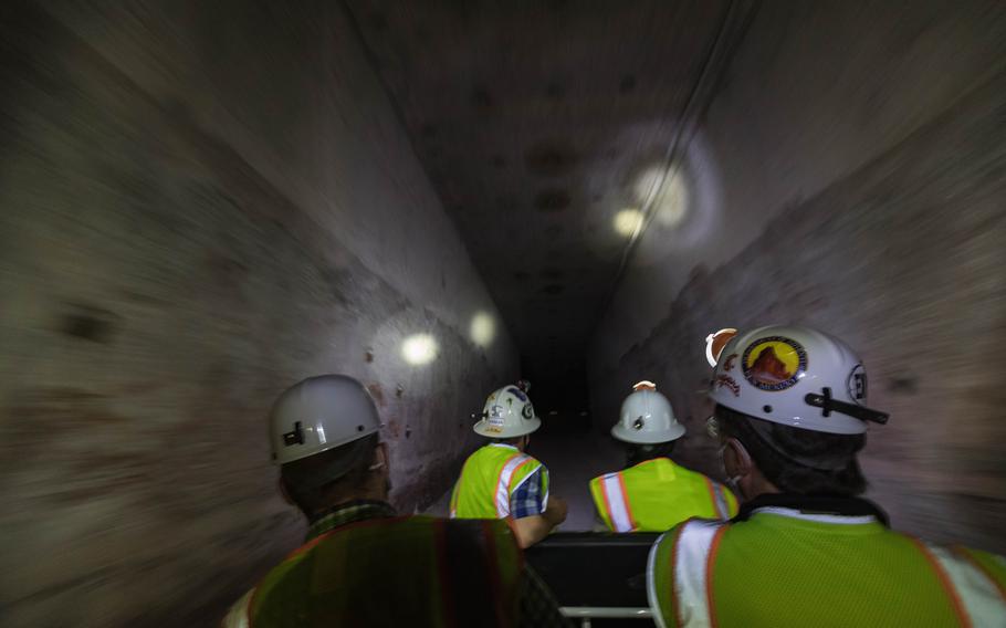 A tour group rides a cart through a geological repository, the US Department of Energy's pilot waste isolation facility, and stores Transuranic radioactive waste in the desert between Hobbs and Carlsbad on August 17, 2021