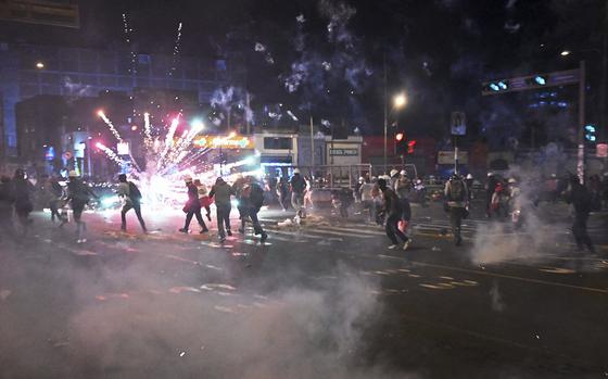 Protesters set off fireworks during a demonstration against the government of Peruvian President Dina Boluarte in Lima on Jan. 31, 2023.  Protesters who have brought parts of Peru to a standstill for weeks closed in on Lima's international airport Tuesday as lawmakers mulled bringing elections forward in a bid to end the deadly mobilization. The South American country has been embroiled in a political crisis with near-daily demonstrations since December 7, when then-president Pedro Castillo was arrested after attempting to dissolve Congress and rule by decree. (Ernesto Benavides/AFP/Getty Images/TNS)