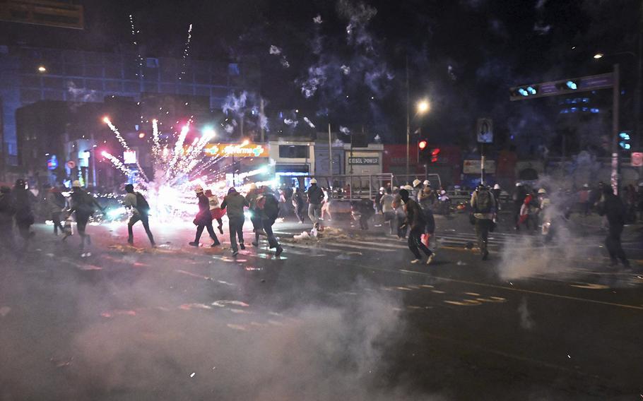 Protesters set off fireworks during a demonstration against the government of Peruvian President Dina Boluarte in Lima on Jan. 31, 2023.  