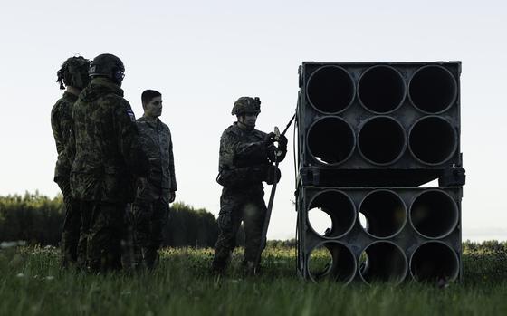(Right) U.S. Army 1st Sgt. Bret Lowery, senior enlisted leader with 3rd Battalion, 27th Field Artillery Regiment, supporting 4th Infantry Division, instructs Estonian Defense Forces soldiers how to properly secure High-Mobility Rocket Artillery System (HIMARS) training-ammunition pods during a sling-load training exercise in Voru, Estonia, Sept. 6. The exercise demonstrated the capability to rapidly deploy HIMARS ammunition anywhere across the Baltics. The 4th Inf. Div.'s mission in Europe is to engage in multinational training and exercises across the continent, working alongside NATO allies and regional security partners to provide combat-credible forces to V Corps, America’s forward deployed corps in Europe. (U.S. Army photo by Staff Sgt. Oscar Gollaz)