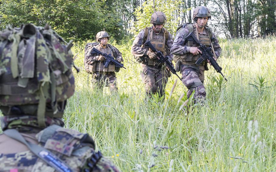 French troops walk through a field after landing in Estonia during a military exercise dubbed Operation Thunder Lynx on Wednesday June 22, 2022. 