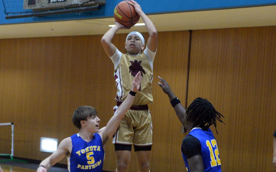 Perry's Jahiion Francoi skies to shoot over Yokota's Sergio Giddens and Jai Bailey.