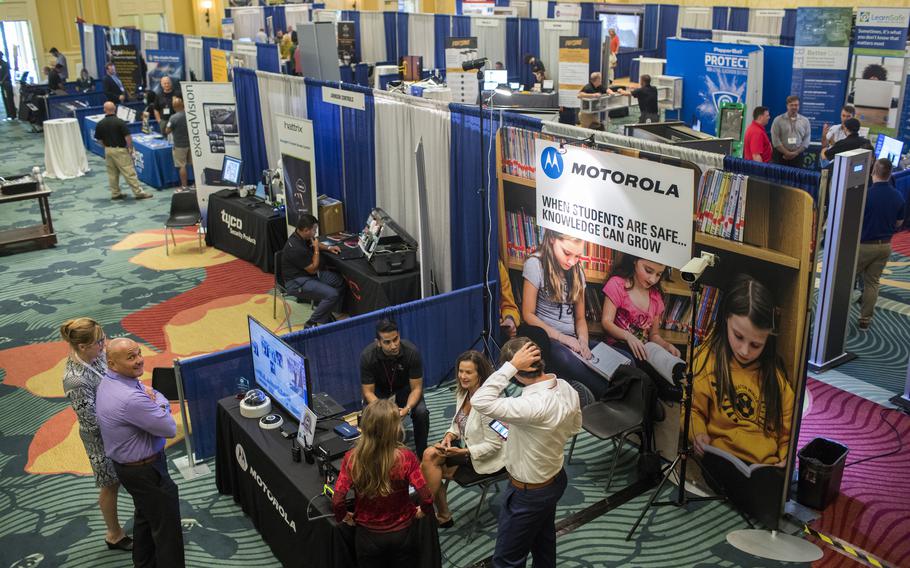 Vendors display their wares at a school security conference in Orlando in 2018 after the Marjory Stoneman Douglas High School attack. U.S. school districts spend $3.1 billion a year on largely unproven security systems. 