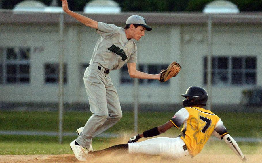 Kadena's Adrian Wilson slides in safely to second base under Kubasaki's Sam Bierman's tag during Monday's DODEA-Okinawa baseball game. The Dragons won 8-3.