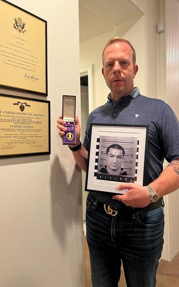 A man poses with a portrait