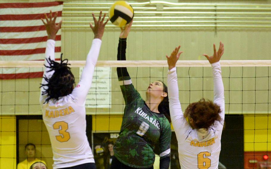 Kubasaki's Olivia Schaffeld spikes between Kadena's Liza Young and Jaci Scriven during Tuesday's Okinawa volleyball match. The Dragons won in four sets and won the season series 3-1.