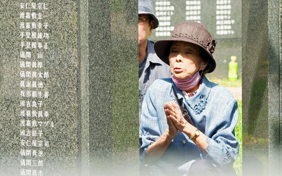 A woman prays for loved ones lost in the Battle of Okinawa during the annual Irei no Hi ceremony at Peace Memorial Park in Itoman, Okinawa, Friday, June 23, 2023.