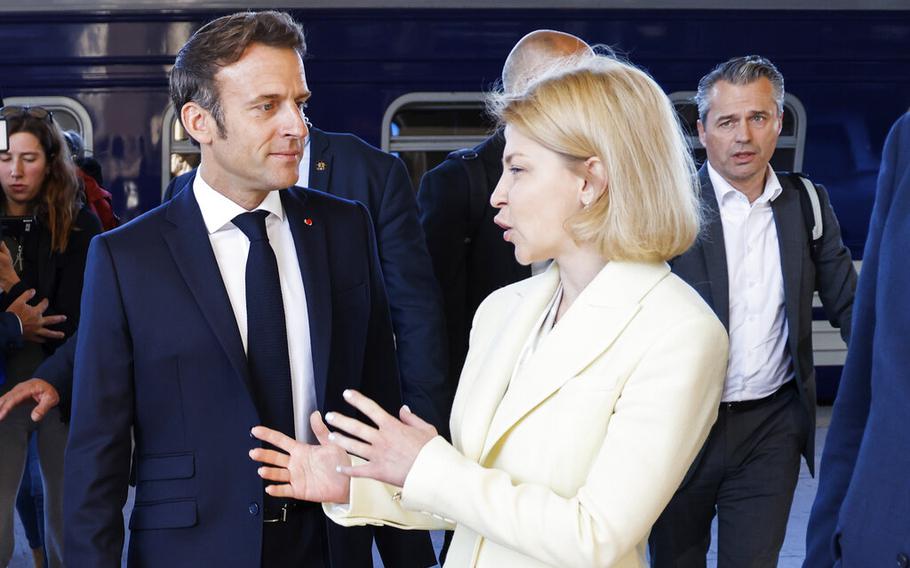 Deputy Prime Minister for European and Euro-Atlantic Integration Olha Stefanishyna , right, welcomes French President Emmanuel Macron at the Kyiv train station, on June 16, 2022.  Stefanishyna said Wednesday, June 22, that she is 100 percent certain that Ukraine will be accepted as a candidate for EU membership.