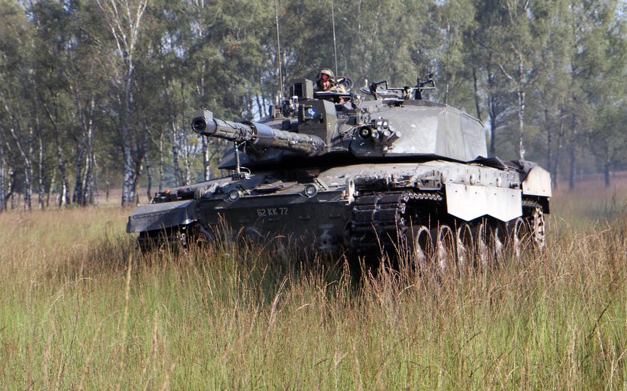 A British Challenger 2 main battle tank maneuvers during an exercise at Sennelager Training Area, Germany, in 2017. 