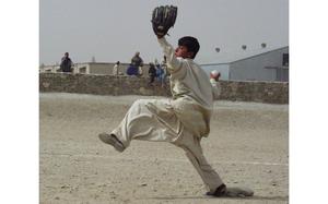 Nasib, 14, fires a pitch during the fourth inning Friday in Orgun-e, Afghanistan. U.S. soldiers have put together two baseball teams with local boys, holding games each Friday.