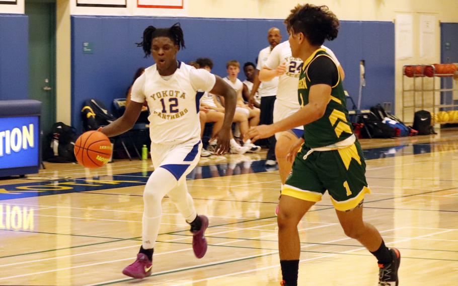 Jai Bailey dribbles up the court.