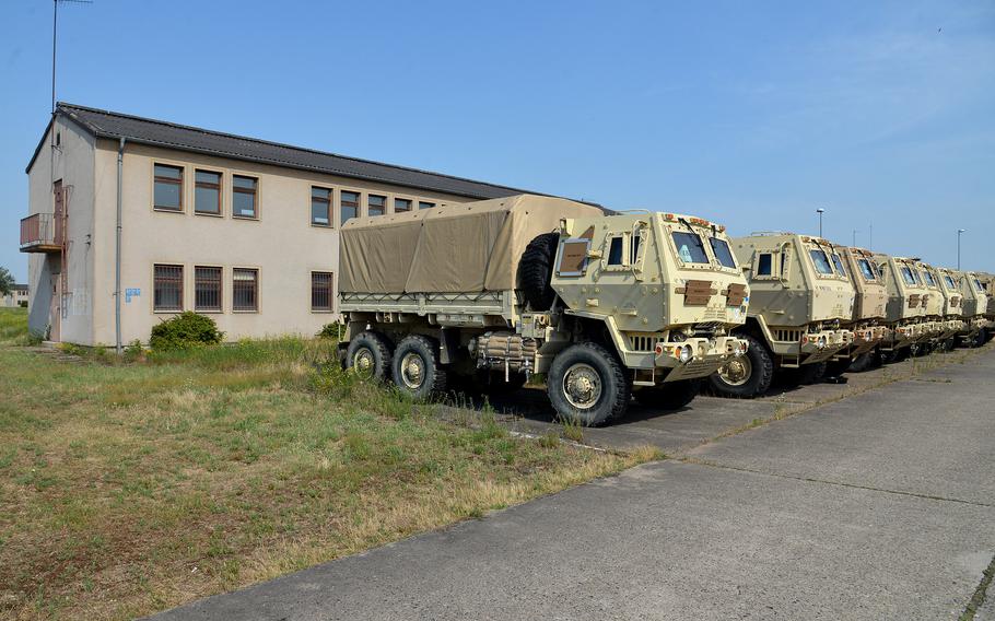 A row of U.S. Army cargo trucks sit in front of one of the old buildings at Coleman Barracks in Mannheim, Germany, in 2017. U.S. Army in Europe and Africa said Aug. 6, 2021, that the military will keep six sites in Germany and Belgium, including Coleman Barracks, that were slated to close under a Pentagon plan to consolidate bases in Europe. 