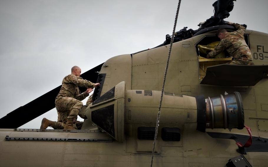 Soldiers assigned to the 1-111th General Support Aviation Battalion conduct daily maintenance and pre-flight inspections on a CH-47F Chinook helicopter at Opa-locka, Florida, on Sept. 28, 2022. 