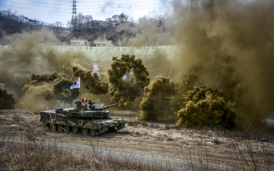 South Korean K1 88 tanks deploy smoke during training for a wet gap crossing along the Imjin River, South Korea, March 20, 2024. 