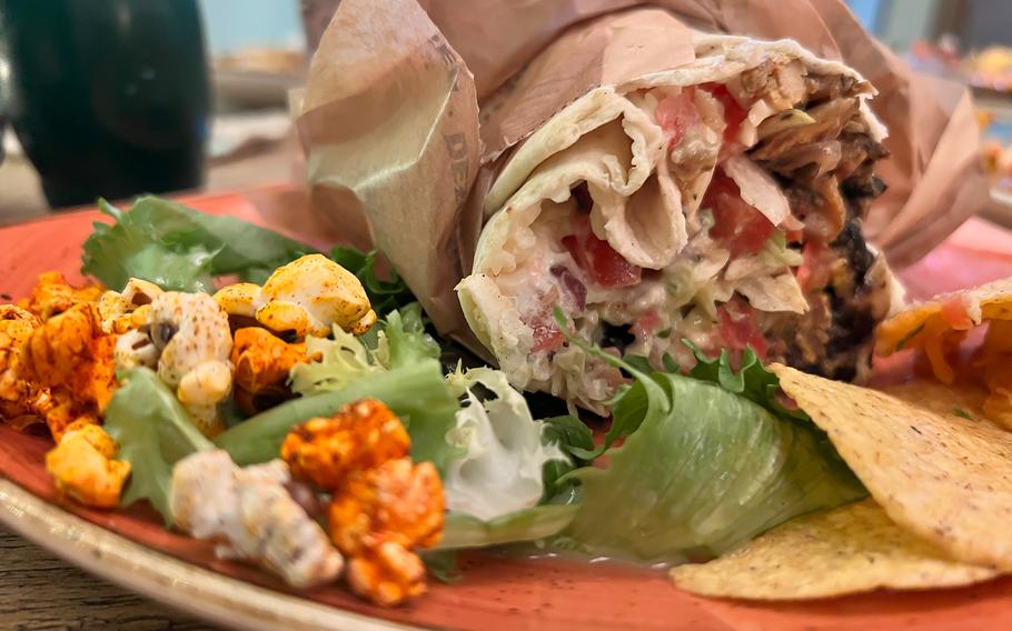 The vegetarian street food burrito at El Burro Restaurant and Bar in Mainz, Germany, comes with seasoned popcorn and corn chips. The vegetarian version of the dish comes either with grilled vegetables or Planted "chicken" made of pea protein. 