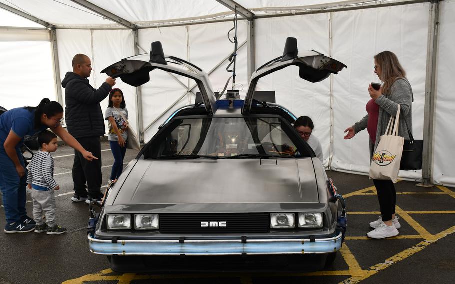 Families get an up-close look at a reproduction of Doc Brown’s DeLorean time machine from the “Back to the Future” trilogy  Oct. 1, 2022, during Mil-D-Con at RAF Mildenhall, England.