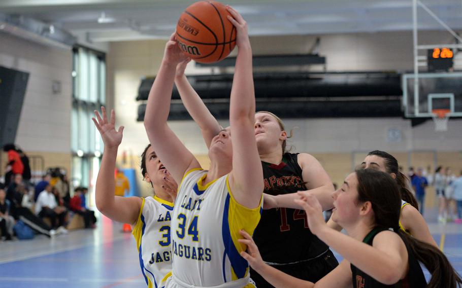 Sigonella’s Laney Reardon pulls down the rebound in front of AFNORTH’s Kailey Koger  in the Division III championship game at the DODEA-Europe basketball finals in Ramstein, Germany, Feb. 18, 2023. Sigonella took the title with a 36-25 win.