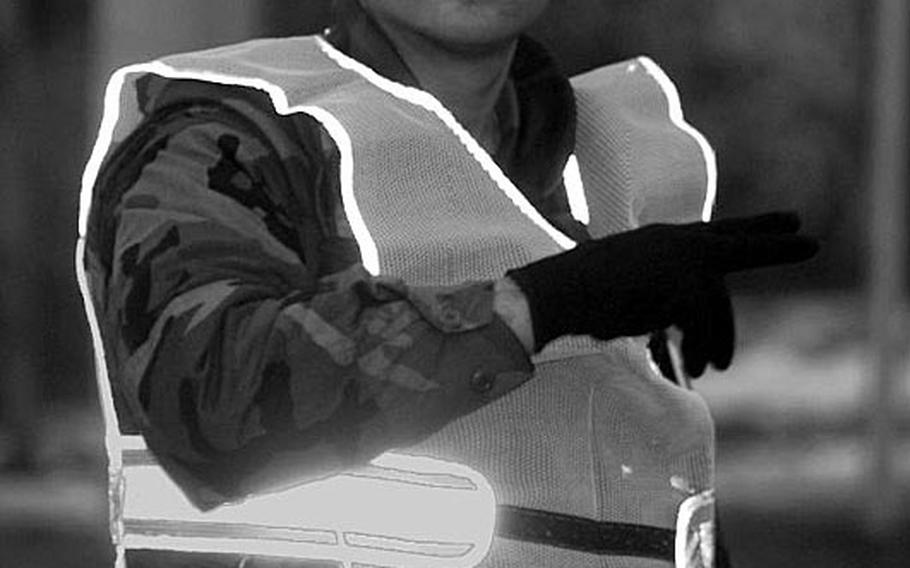 Taszar AB, Hungary, January, 1996: A soldier directs traffic at a busy intersection at Taszar AB