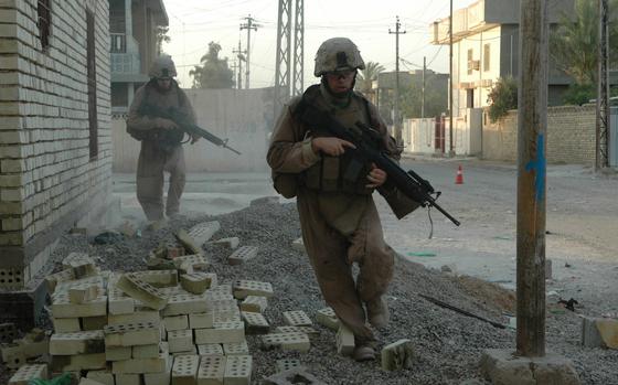 Fallujah, Iraq, July 19, 2006: Marines from 1st Platoon, Company C, 1st Battalion, 25th Marine Regiment dash for cover in Fallujah after a sniper began firing into the street.

RELATED: Marines go insurgent hunting in Fallujah  https://www.stripes.com/news/marines-go-insurgent-hunting-in-fallujah-1.51921

META TAGS: Operation Iraqi Freedom, War on Terror, U.S. Army, USMC; U.S. Marine Corps
