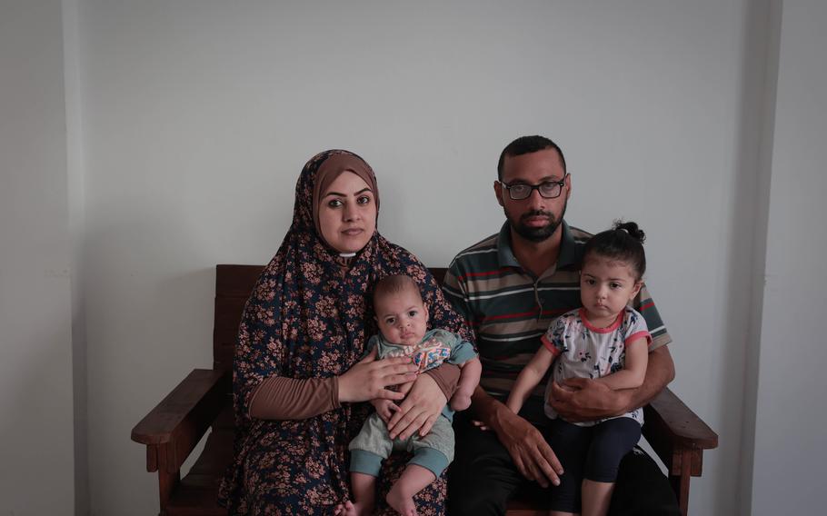 Raed Asad with his wife, Salwa, and two of their children in the northern Gaza Strip on Sept. 7. Asad has a degree in medical administration but has only ever found work in the fields.