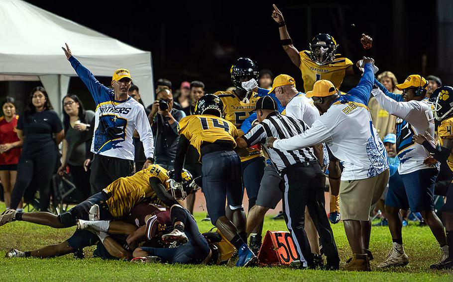 Guam High's sideline celebrates after Cameron Brantley's fumble recovery.