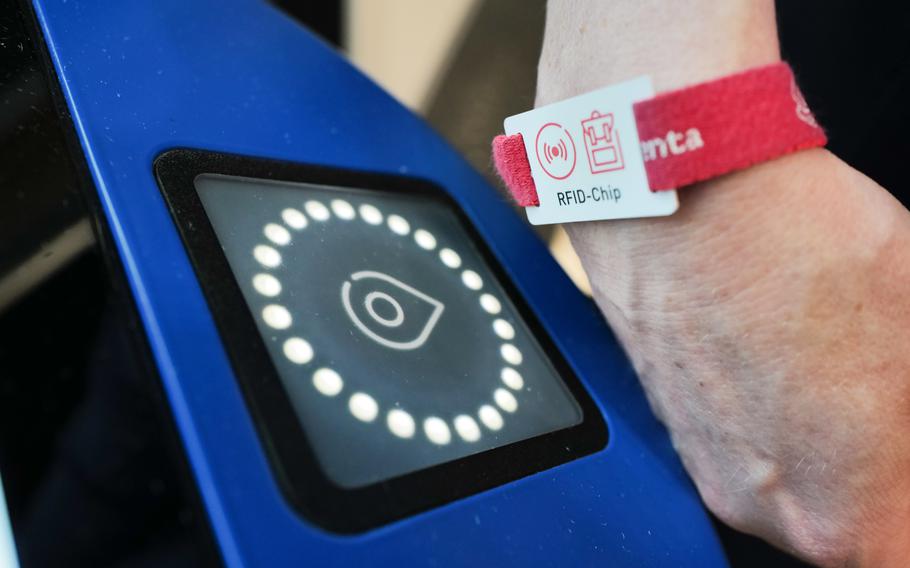 A guest scans an RFID chip at an interactive station in the Experimenta Science Center, allowing them to save images and videos of their experiments for later access.