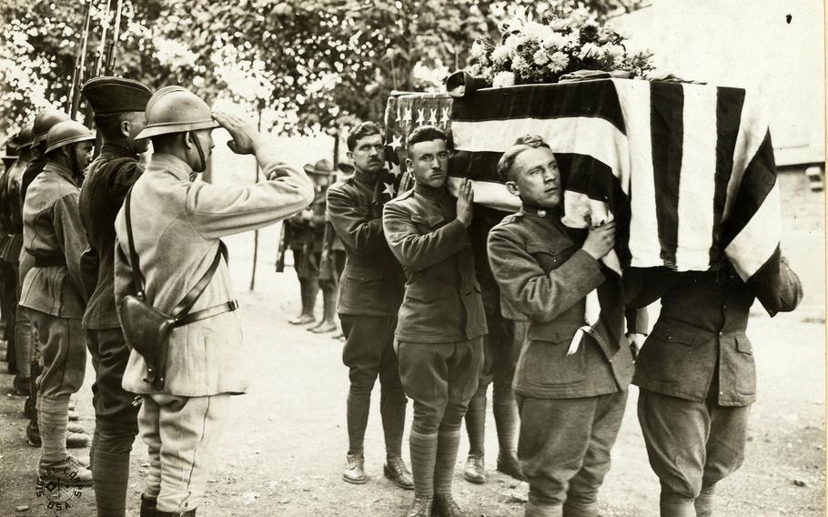 French and American Soldiers salute at the funeral of one of their comrades at base hospital No. 17, Dijon, France, on Sept. 6, 1918. 