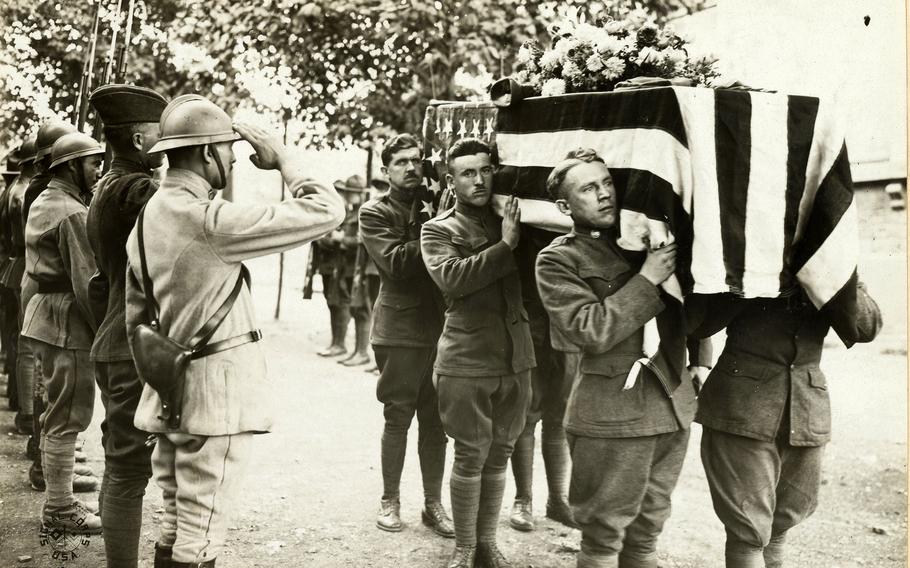 French and American Soldiers salute at the funeral of one of their comrades at base hospital No. 17, Dijon, France, on Sept. 6, 1918. 