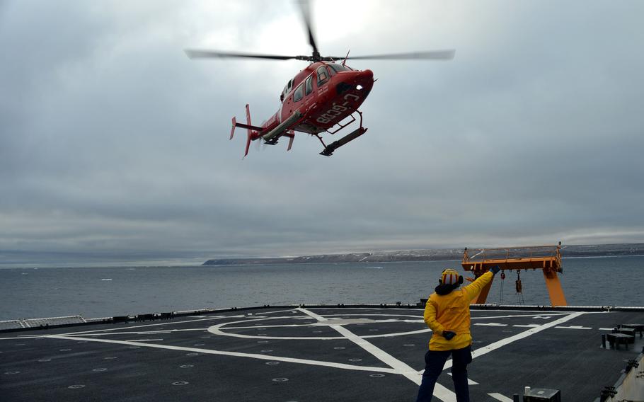 Lt. j.g. Ainsley Fruhwirth directs a Canadian coast guard helicopter crew to take off from Healy near Resolute, Canada, on Sept. 6, 2021. The Defense Department has appointed retired Air Force Maj. Gen. Randy “Church” Kee as its senior adviser for Arctic security.