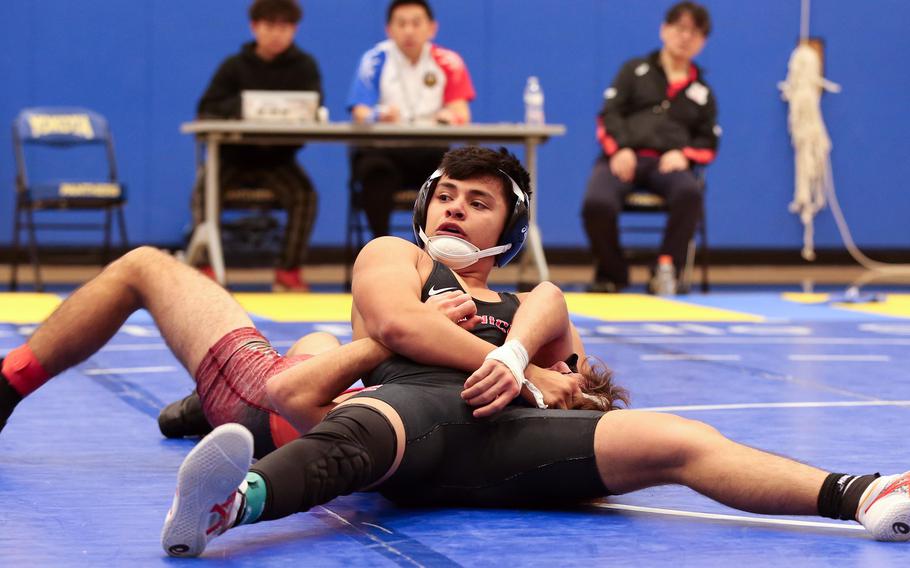 Nile C. Kinnick's Sam Tovar takes charge of Yokota's Kai Patton in the 133-pound final during Saturday's Yokota wrestling tournament.
