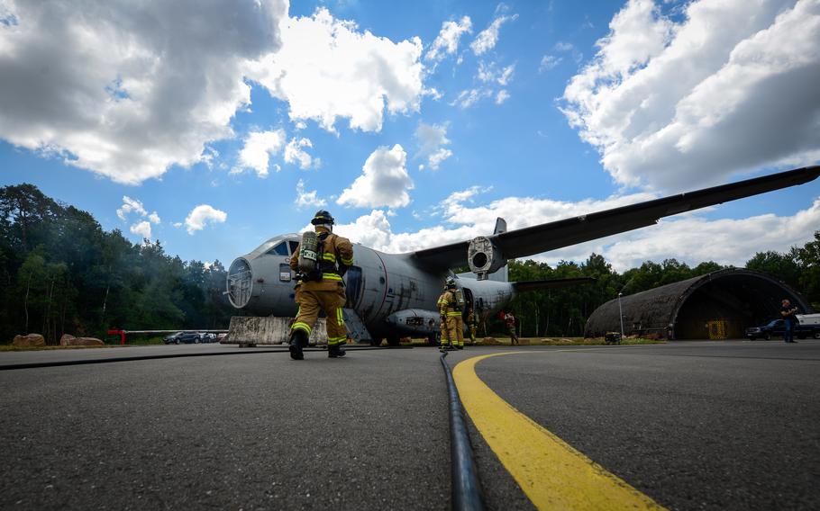 Firefighters assigned to the 86th Civil Engineer Group respond to a simulated aircraft crash during Operation Varsity at Ramstein Air Base, Germany, July 26, 2022. During the exercise scenario, firefighters were challenged to respond to an aircraft that missed the flight line and crash-landed with seven airmen on board.