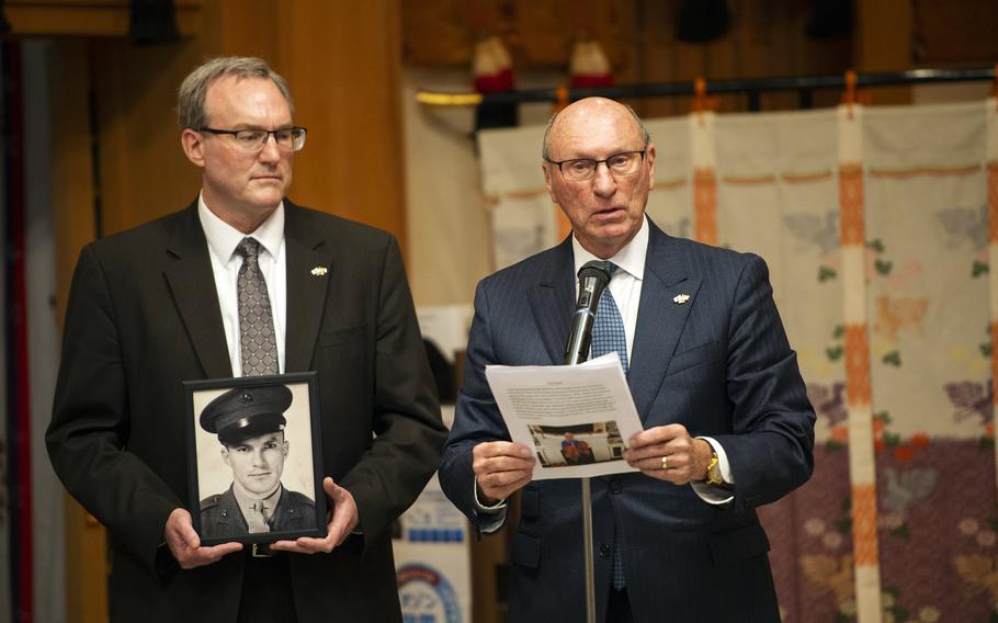 Richard and Chris Johnson honor their father and grandfather, Marine veteran Richard Wanlass Johnson, during a flag-return ceremony at Gokoku Shrine in Hiroshima, Japan, Sunday, Dec. 4, 2022.