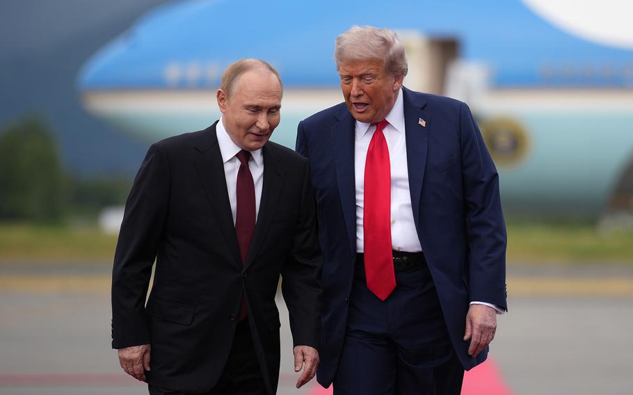 U.S. President Donald Trump walks with Russian President Vladimir Putin