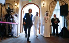 United States Secretary of State Antony Blinken, center left, and Qatar Foreign Minister Mohammed Bin Adbulrahman Al Thani, center right, walk to a press conference at the Diplomatic Club, in Tuesday, Nov. 22, 2022. America's top diplomat criticized a decision by FIFA to threaten players at the World Cup with yellow cards if they wear armbands supporting inclusion and diversity. (AP Photo/Ashley Landis)