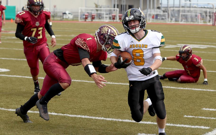 Robert D. Edgren's Daniel Phillips tries to create some running space against Matthew C. Perry's Jordan Wooten.