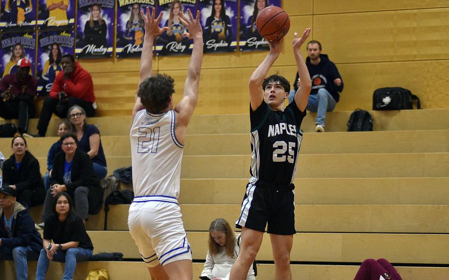Naples junior Jettyn Jones shoots over Rota senior Tyler DeMerritt during a Division II semifinal at the DODEA European Basketball Championships on Feb. 16, 2024, at Wiesbaden High School in Wiesbaden, Germany.