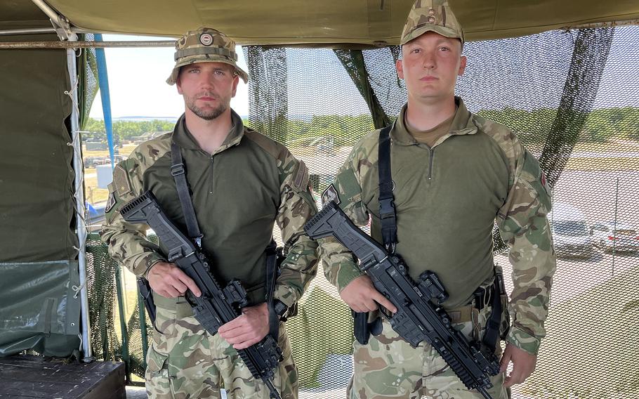 Lynx platoon leaders hold weapons while posing for a photo.