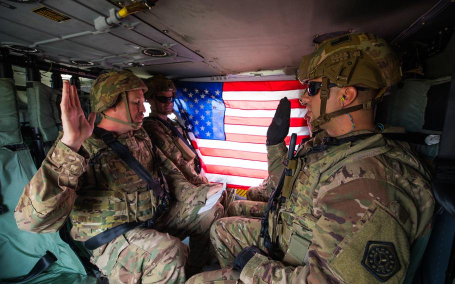 Sgt. Alex Apostolou, a maintenance noncommissioned officer with the 108th Sustainment Brigade Task Force Lincoln, Team Blackhawks, reenlisted into the U.S. Army aboard a UH-60 Black Hawk helicopter on Dec. 6, 2019, over the skies of Baghdad, Iraq. The reenlistment ceremony was administered by Chief Warrant Officer 2 Lucas Miles, S1 Officer in Charge, with the 108th Sustainment Brigade. (U.S. Army National Guard photo by Sgt. William Ploeg)