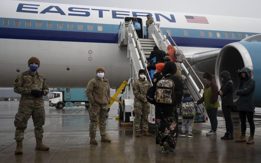 Afghan evacuees board the final flight to the United States from Ramstein Air Base, Germany, Oct. 30, 2021.