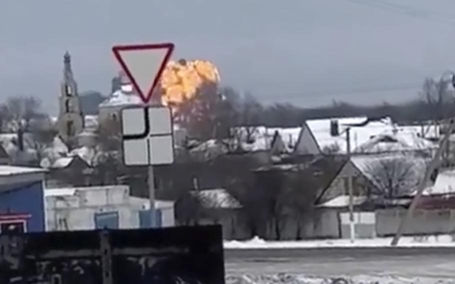 This handout photo taken from validated UGC video shows flames rising from the scene of a warplane crash at a residential area near Yablonovo, Belgorod region, Jan. 24, 2024. 
